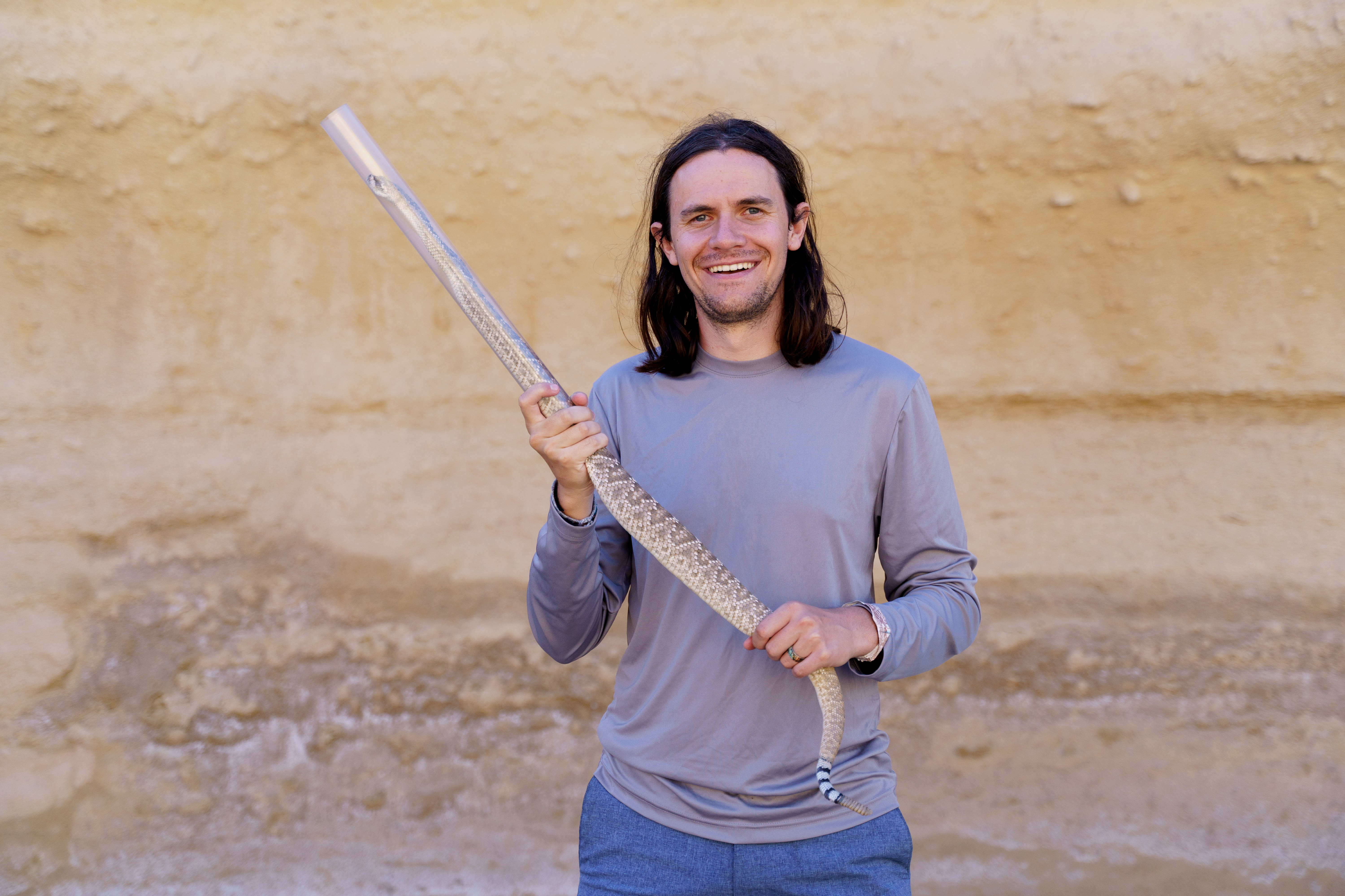 Sam Hirst holding a rattlesnake in Baja California